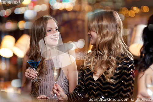 Image of happy women with drinks at night club