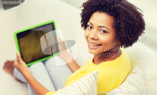 Image of happy african american woman with tablet pc