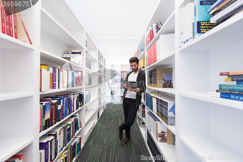 Image of student with tablet in library