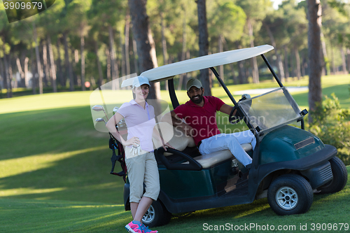 Image of couple in buggy on golf course