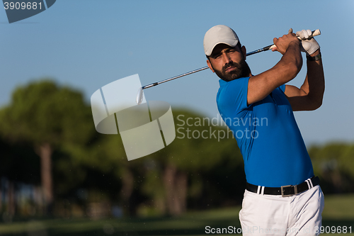 Image of pro golfer hitting a sand bunker shot