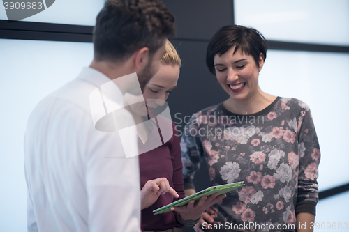 Image of young business people group working on tablet