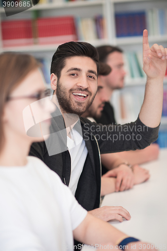 Image of group of students  raise hands up