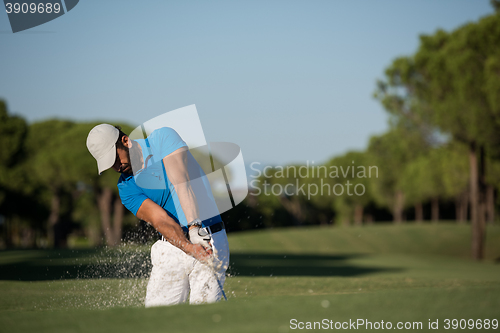 Image of pro golfer hitting a sand bunker shot