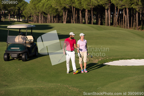 Image of couple walking on golf course