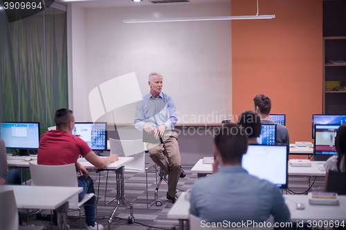 Image of teacher and students in computer lab classroom