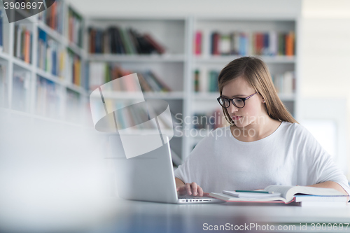 Image of female student study in school library