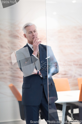 Image of portrait of handsome senior business man at modern office