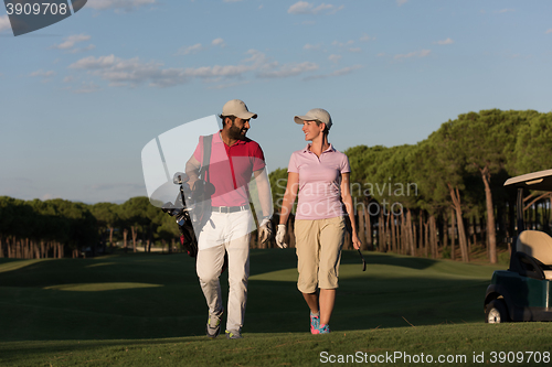Image of couple walking on golf course