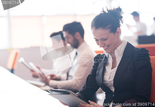 Image of business woman on meeting  using tablet