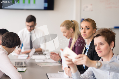 Image of young business people group on team meeting at modern office