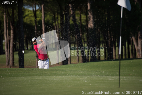 Image of golfer hitting a sand bunker shot