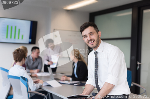 Image of young business man with tablet at office meeting room