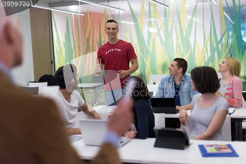 Image of teacher with a group of students in classroom