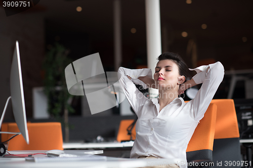 Image of happy young business woman relaxing and geting insiration