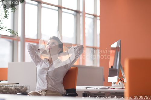 Image of happy young business woman relaxing and geting insiration