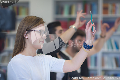 Image of group of students  raise hands up