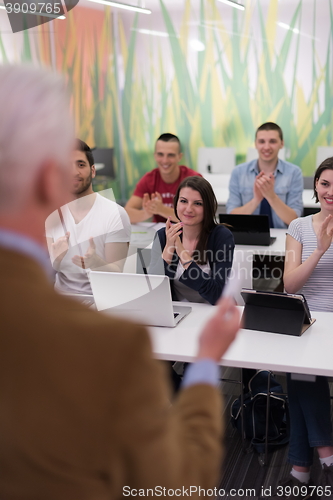 Image of teacher with a group of students in classroom