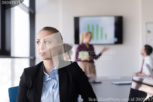 Image of portrait of young business woman at office with team on meeting 
