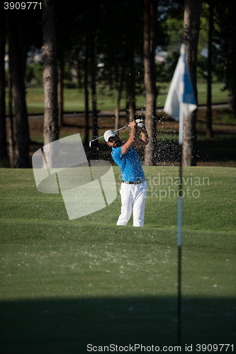 Image of pro golfer hitting a sand bunker shot