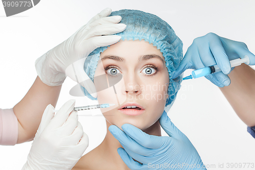 Image of Attractive woman at plastic surgery with syringe in her face