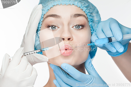 Image of Attractive woman at plastic surgery with syringe in her face