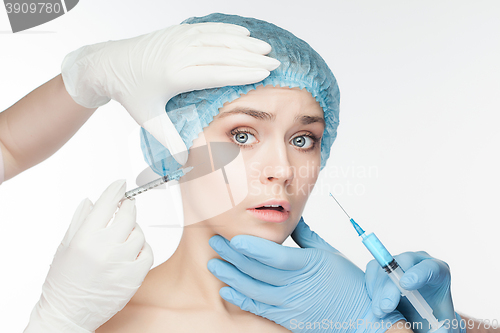 Image of Attractive woman at plastic surgery with syringe in her face