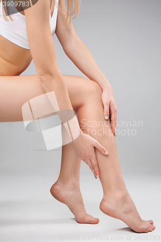 Image of Female legs and hands, white background