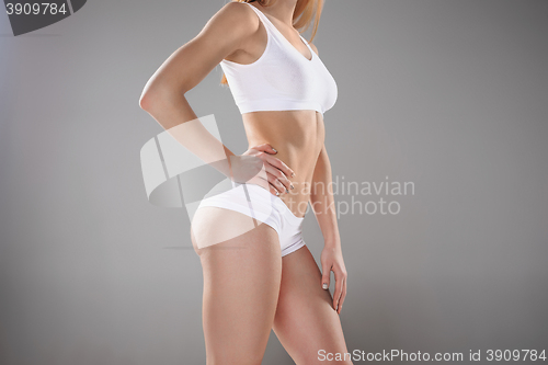 Image of Young, slim, healthy and beautiful woman in white lingerie