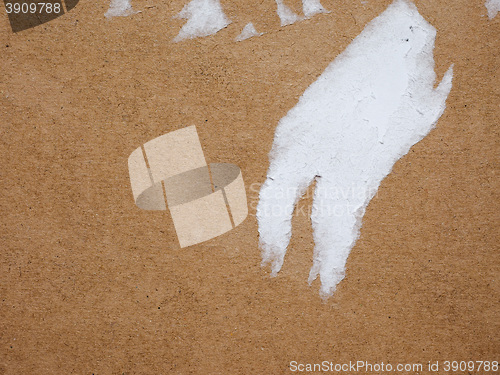 Image of Brown corrugated cardboard background with ripped label