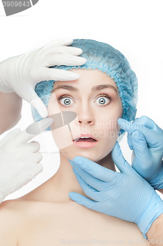 Image of Plastic surgery concept. Doctor hands in gloves touching woman face