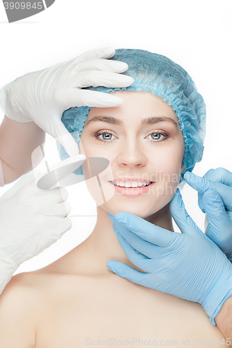 Image of Plastic surgery concept. Doctor hands in gloves touching woman face