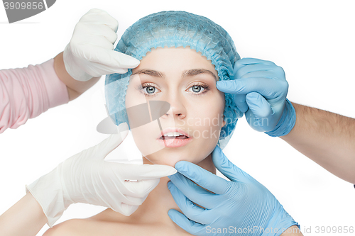 Image of Plastic surgery concept. Doctor hands in gloves touching woman face