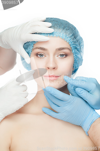 Image of Plastic surgery concept. Doctor hands in gloves touching woman face