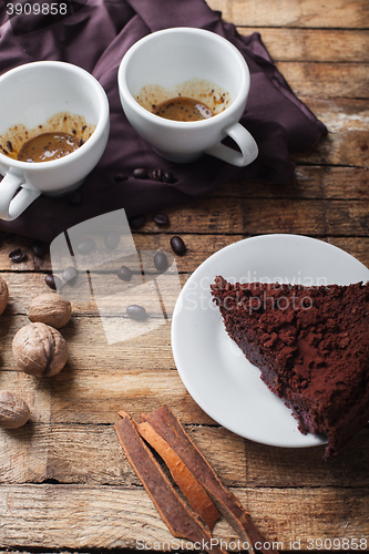 Image of Chocolate cake, coffee and cinnamon sticks