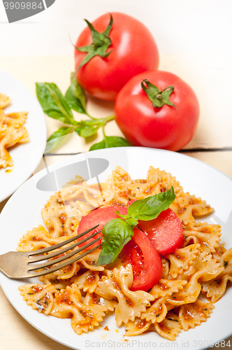 Image of Italian pasta farfalle butterfly bow-tie and tomato sauce