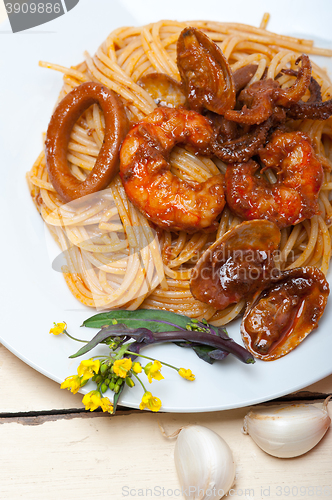 Image of Italian seafood spaghetti pasta on red tomato sauce 