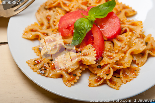 Image of Italian pasta farfalle butterfly bow-tie and tomato sauce