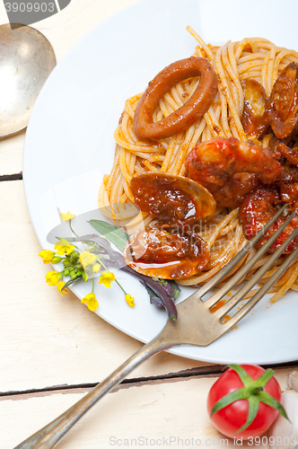 Image of Italian seafood spaghetti pasta on red tomato sauce 