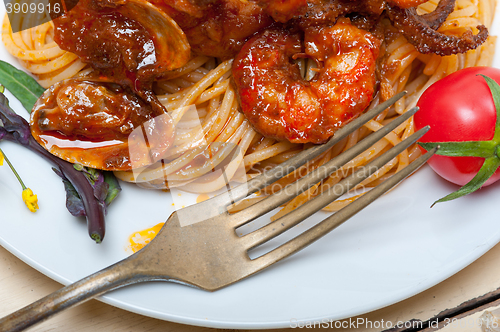 Image of Italian seafood spaghetti pasta on red tomato sauce 