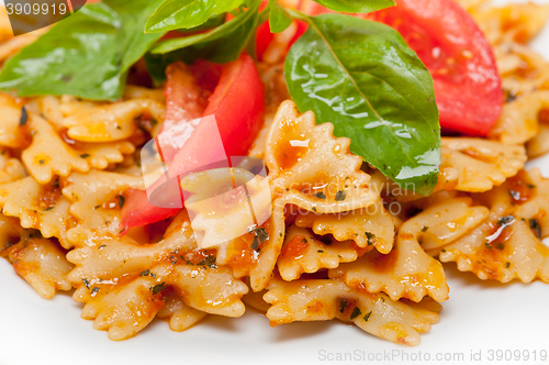 Image of Italian pasta farfalle butterfly bow-tie and tomato sauce