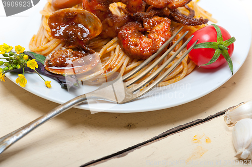 Image of Italian seafood spaghetti pasta on red tomato sauce 