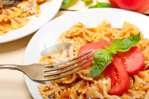 Image of Italian pasta farfalle butterfly bow-tie and tomato sauce