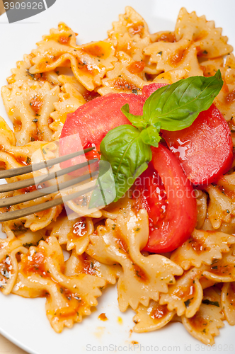 Image of Italian pasta farfalle butterfly bow-tie and tomato sauce