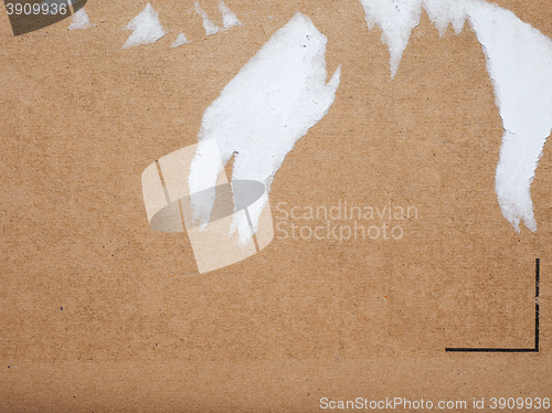 Image of Brown corrugated cardboard background with ripped label