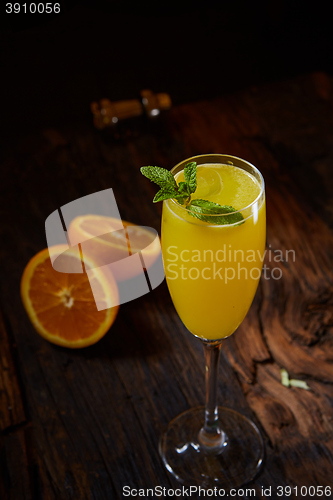 Image of Orange cocktail on rustic wooden table