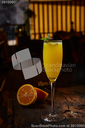 Image of Orange cocktail on rustic wooden table