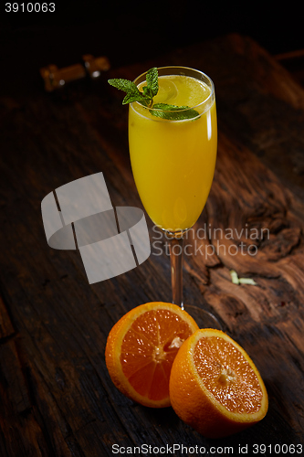 Image of Orange cocktail on rustic wooden table