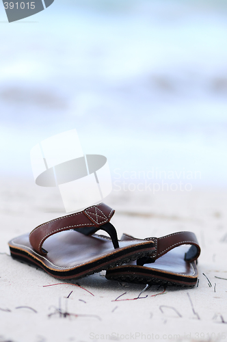 Image of Flipflops on a sandy beach