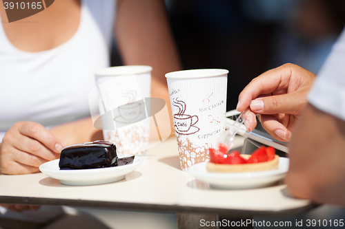 Image of Couple enjoying coffee and cake at a cafeteria